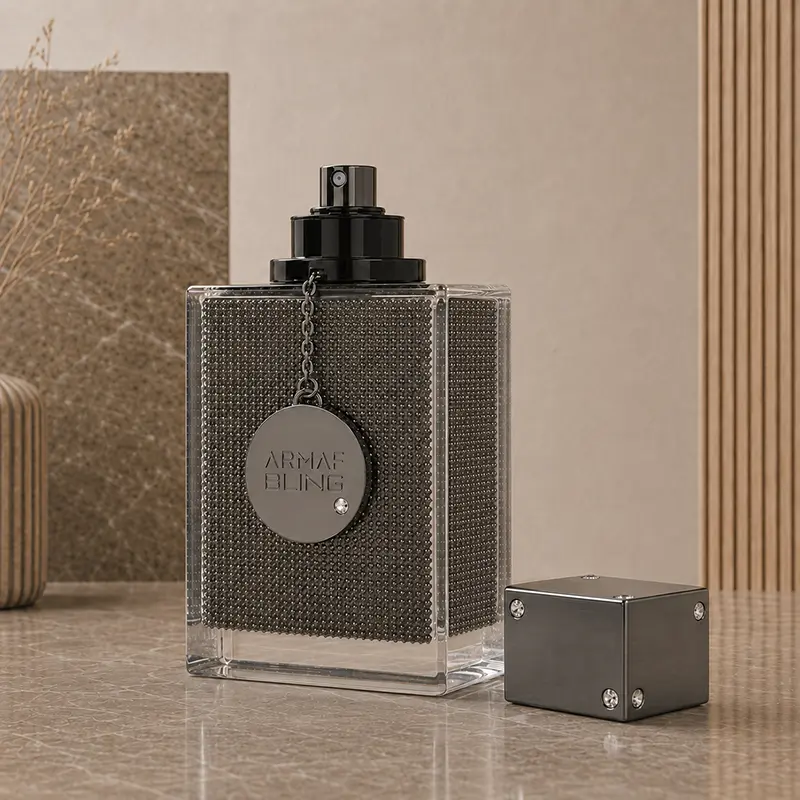 Spray nozzle exposed on the Club de Nuit Bling bottle, with the studded cube cap placed beside it