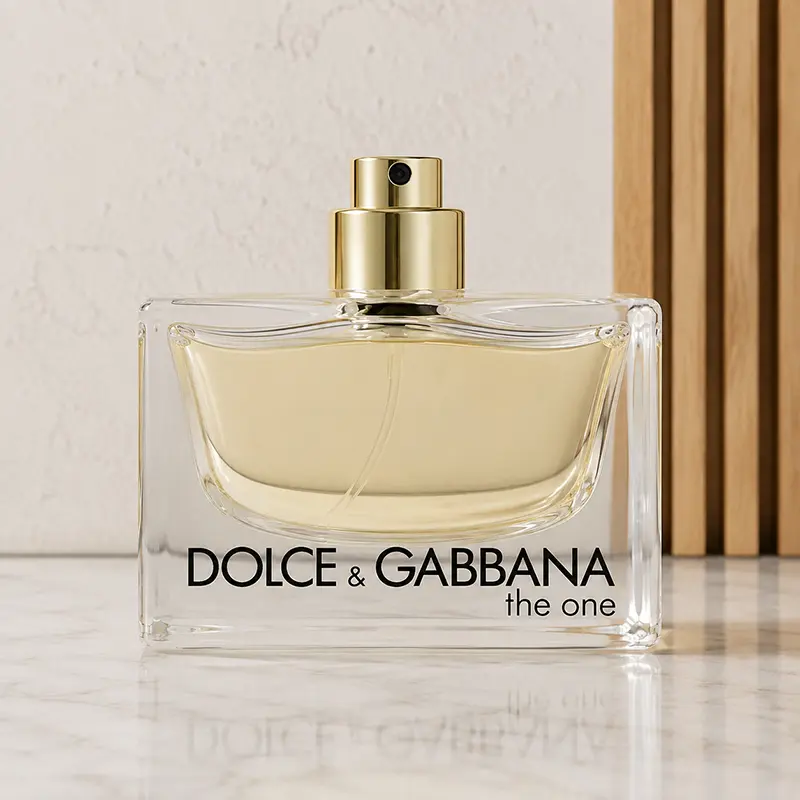 Gold atomiser exposed on a Dolce&Gabbana The One perfume bottle in a neutral studio setting