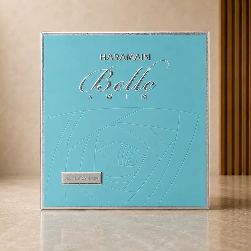 Haramain Belle Swim 75ml turquoise perfume box shown front-on in the gallery studio