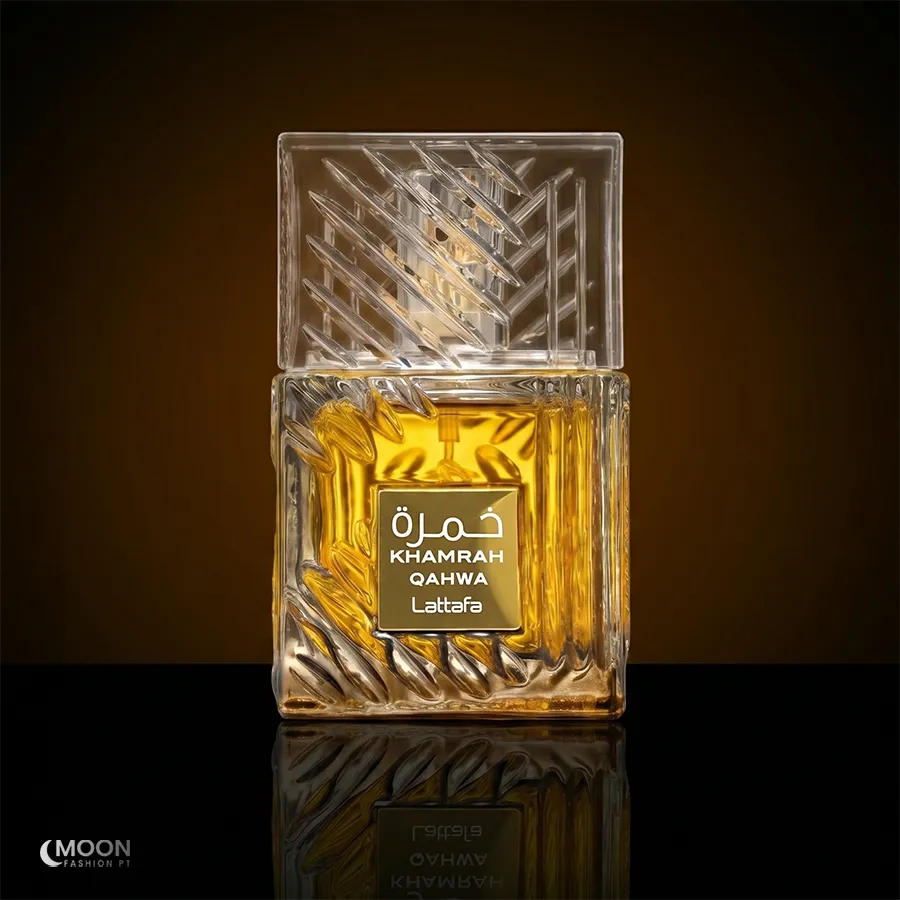 The elegant faceted glass bottle of Khamrah Qahwa by Lattafa, presented on a polished noir surface for unisex appeal.