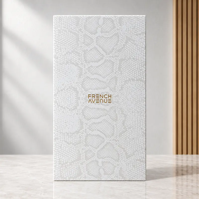 White snakeskin-patterned inner box for Vulcan Baie with the French Avenue logo.