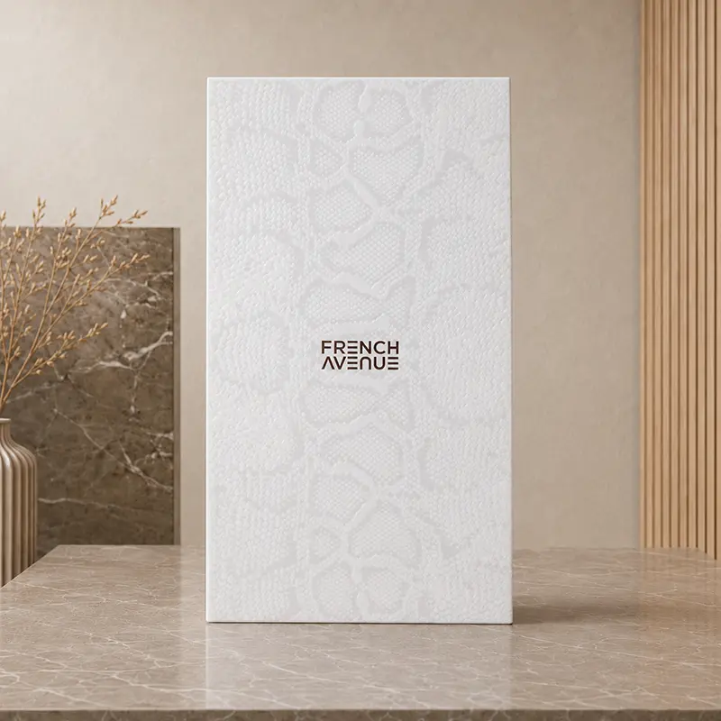 White French Avenue inner box with a subtle snakeskin pattern, shown closed on a stone-effect surface.