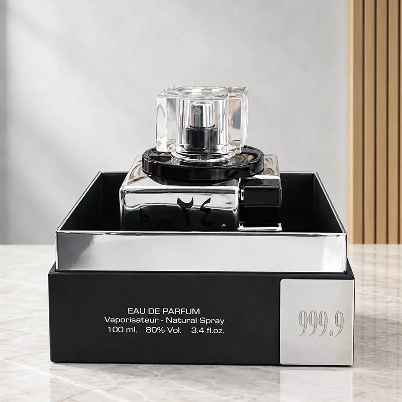 24 Carat White Gold perfume bottle displayed in an open black tray with a reflective silver front.