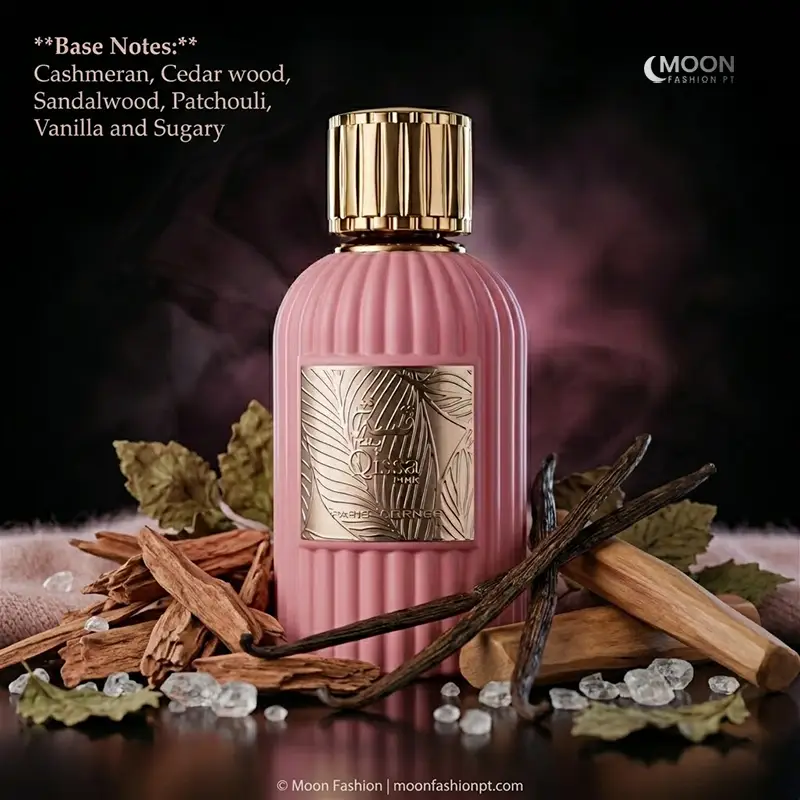 A feminine Qissa Pink bottle rests among aromatic sandalwood and vanilla pods for a warm, sugary finish.